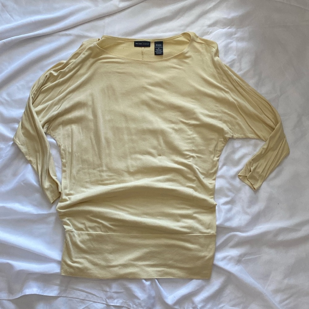 Cream colored dolman style blouse, 3/4 sleeves, wide hip band